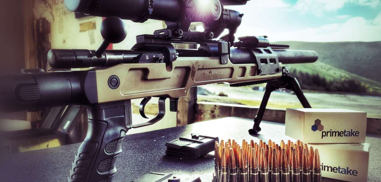 rifle and tripod on table with ammo boxes